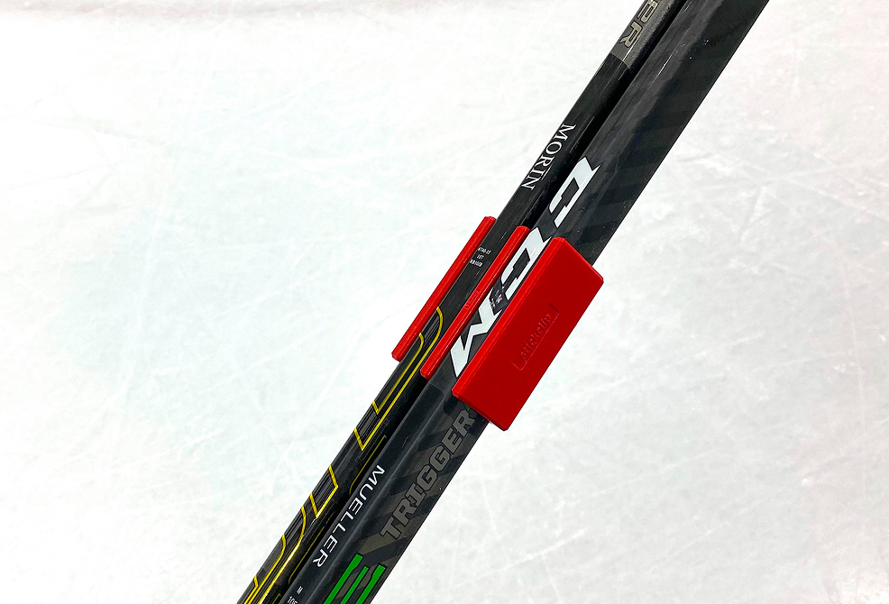 StickClip holding two hockey sticks together